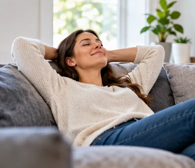 Woman relaxing on a couch in a cool, bright room